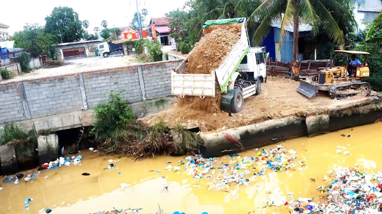 Activities of pouring soil into flooded areas and mixing garbage with small machinery