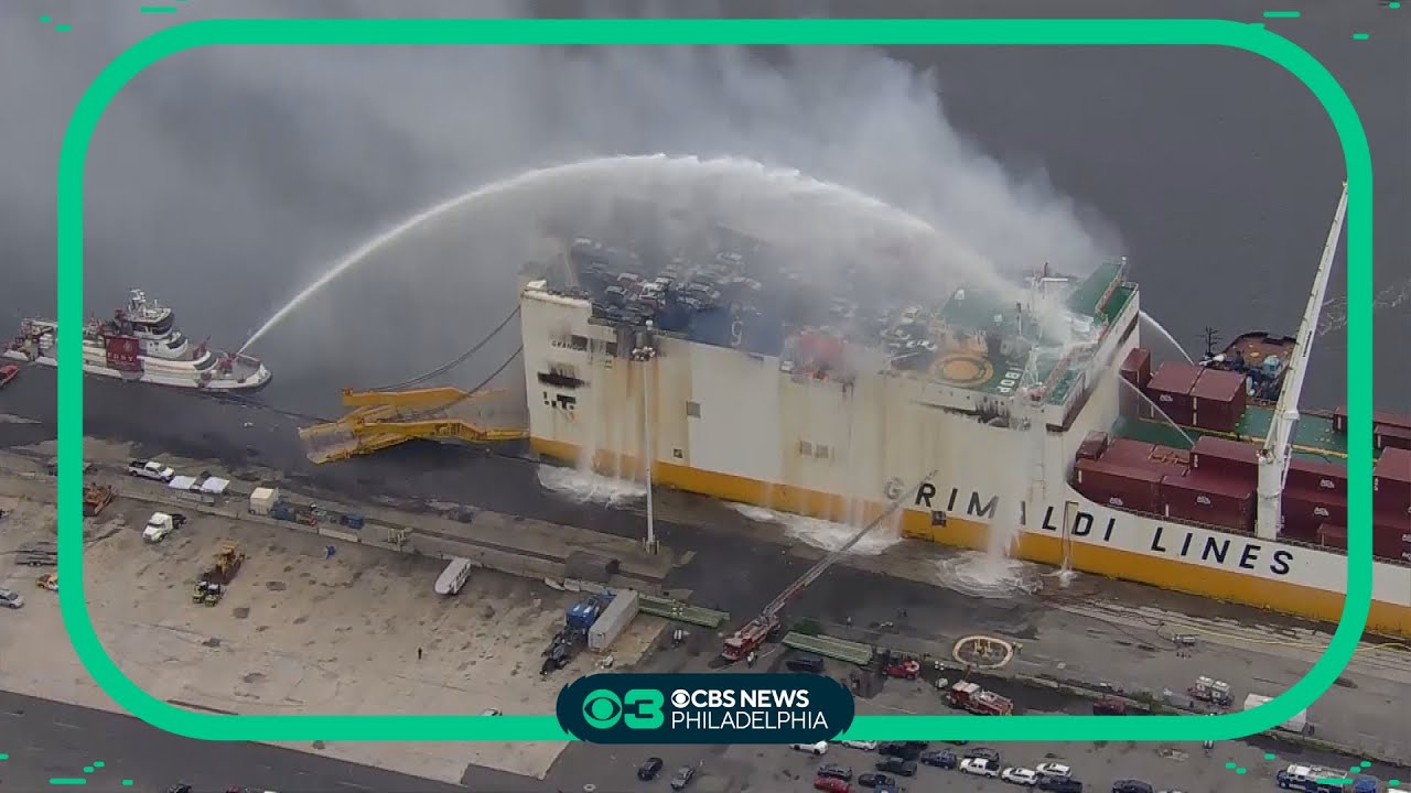 Burning cargo ship tilting in Port Newark, NJ