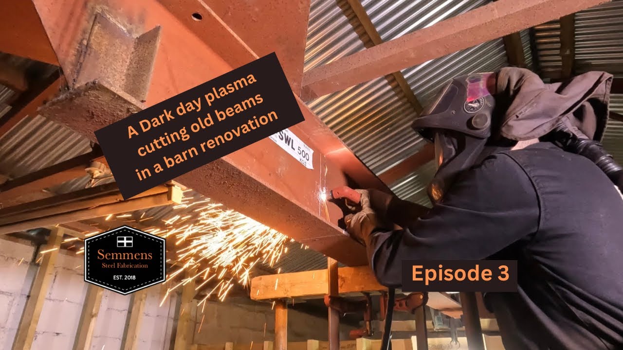 A dark and dusty day plasma cutting redundant beams in a barn renovation