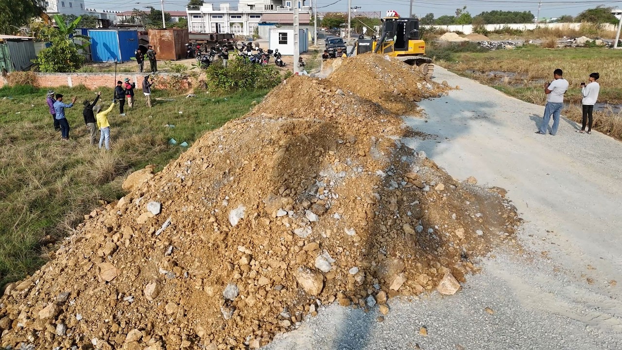 Great Start! Land filling bulldozers & dump trucks working perfect coordination, moving soil & stone