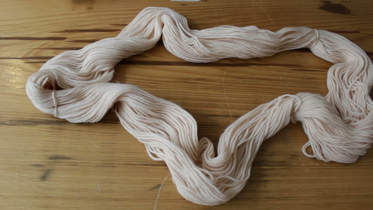 hand winding a skein of yarn into a ball