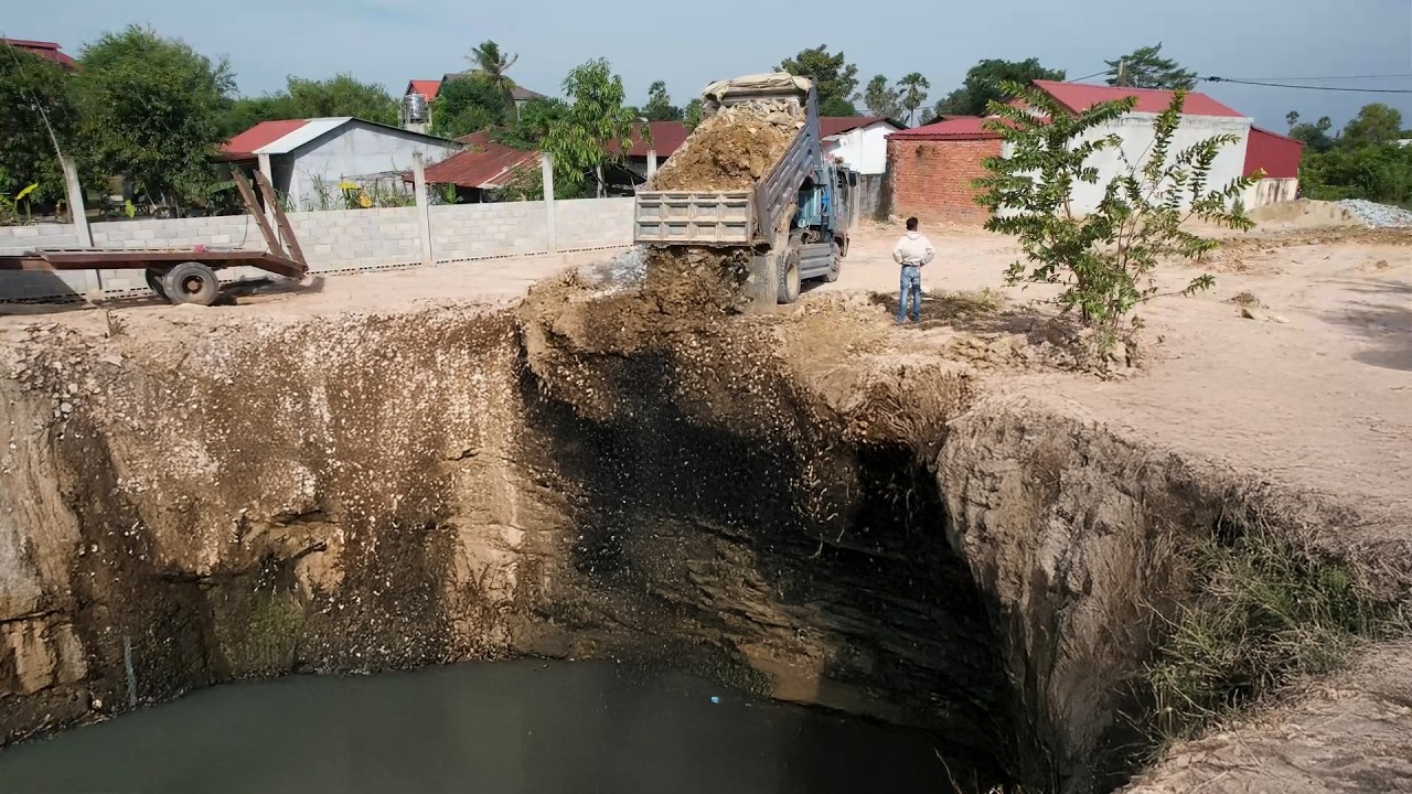 Project! Dump Truck dumped soil to Delete pond Flooded with bulldozer Pushing