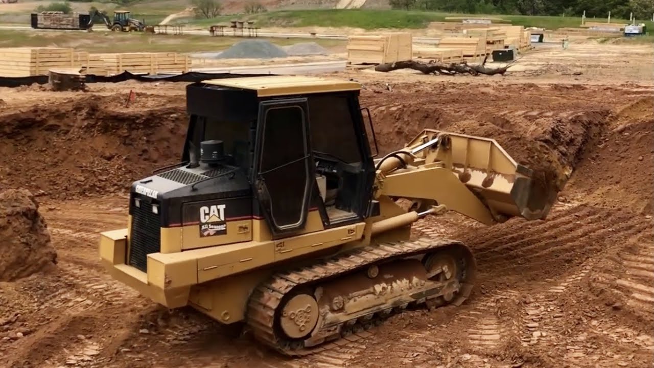CAT 953C Loader Digging a Basement and Tracking a Hill