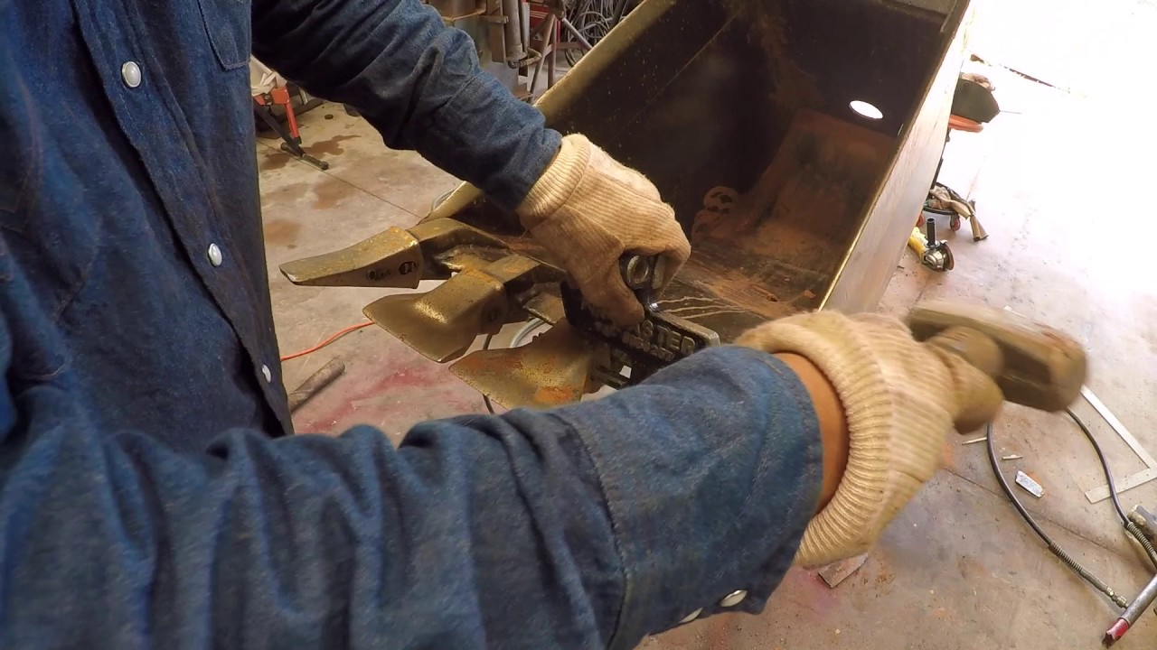 How to change backhoe teeth