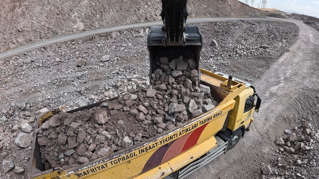 Hidromek Excavator I loaded stony material onto trucks