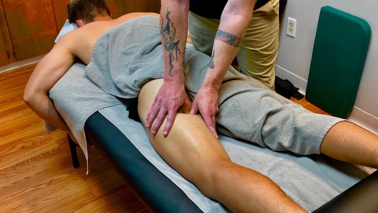 Sports massage soccer player with hamstring injury