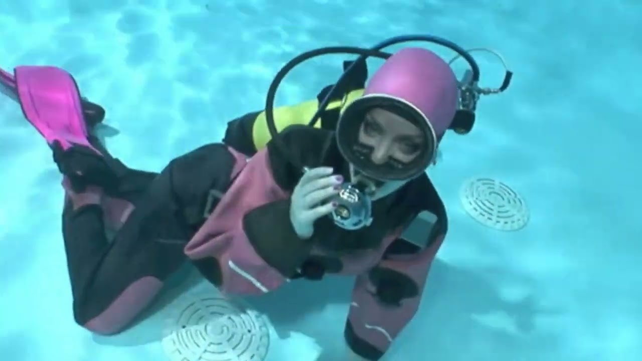 Female Diver is Diving with Rubber Drysuit and Swim Cap