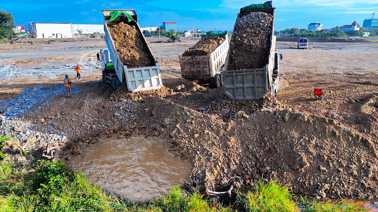 Great operators working in filling land and pushing soil