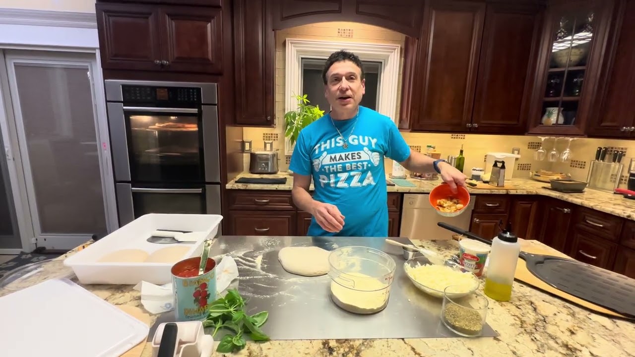 Preparing the second pizza as the first bakes.  