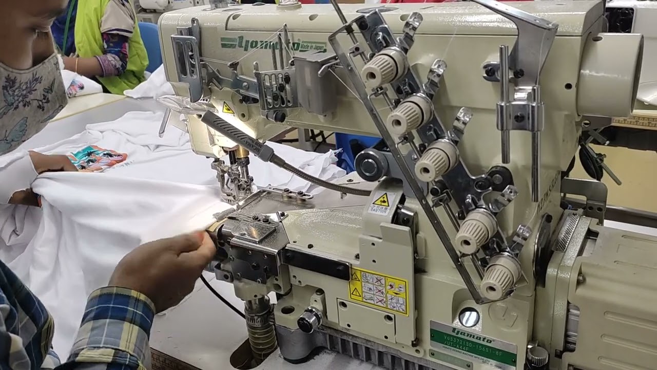 Flatlock sewing machine. bottom hem. basic t shirt. very skill operator.