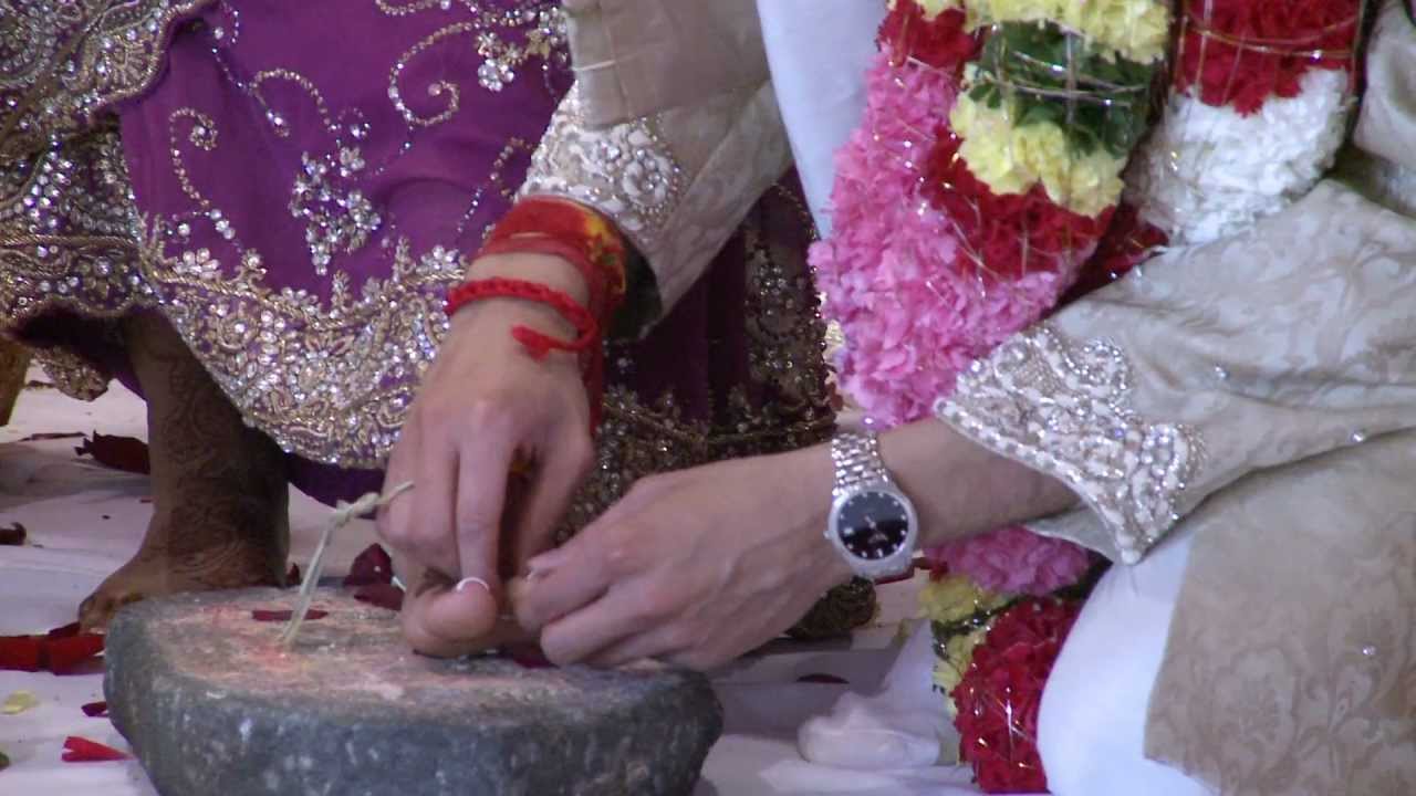 Bichiya Ceremony at Hindu Heritage Centre in Mississauga - Groom Puts Wedding Ring on Bride's Toe