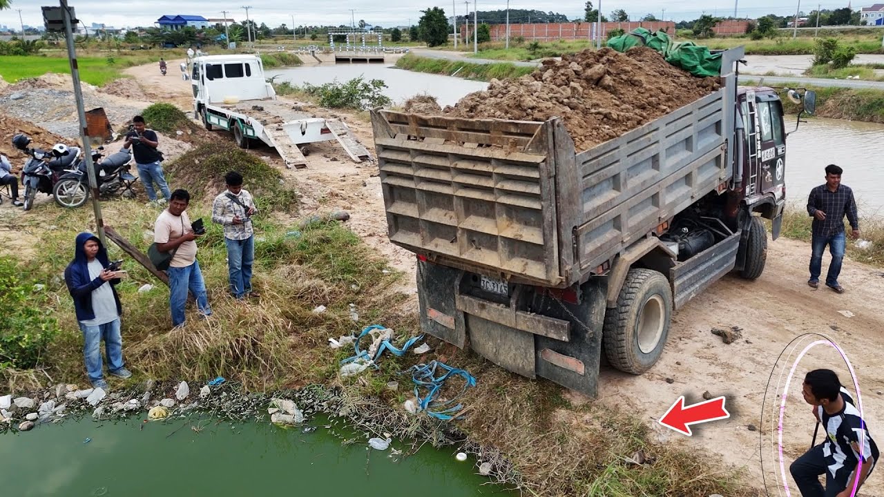 Process Start landfill using dump trucks 5ton drop fill soil flooded & pushing by Dozer KomatSu