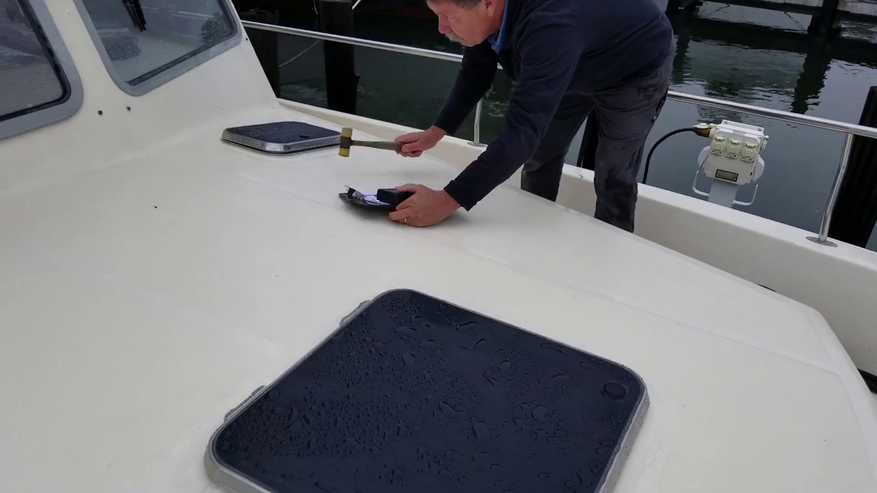surveyor checking hull tapping