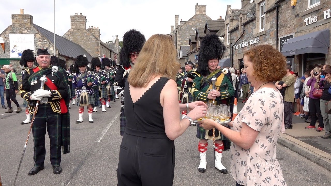 Massed Pipes & Drums parade stops to enjoy a wee dram before 177th Tomintoul Highland Games