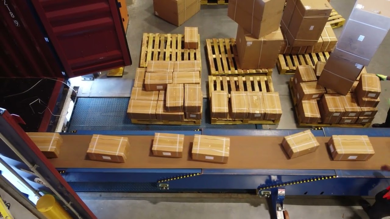 TRUCK OFF-LOADING CONVEYOR SYSTEM AT RECEIVING BAYS