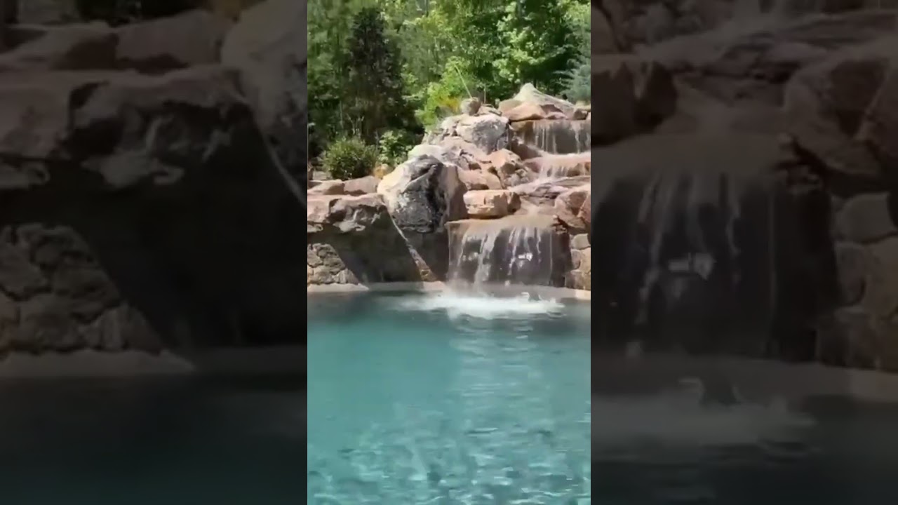 Custom Pool with Waterfall and Slide #waterfall #outdoorliving #pool #swimmingpool #pools #backyard