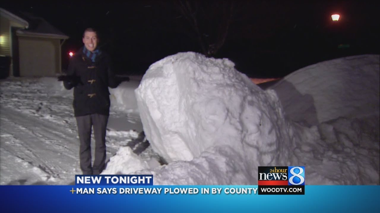 Plow pushes snow chunk into driveway