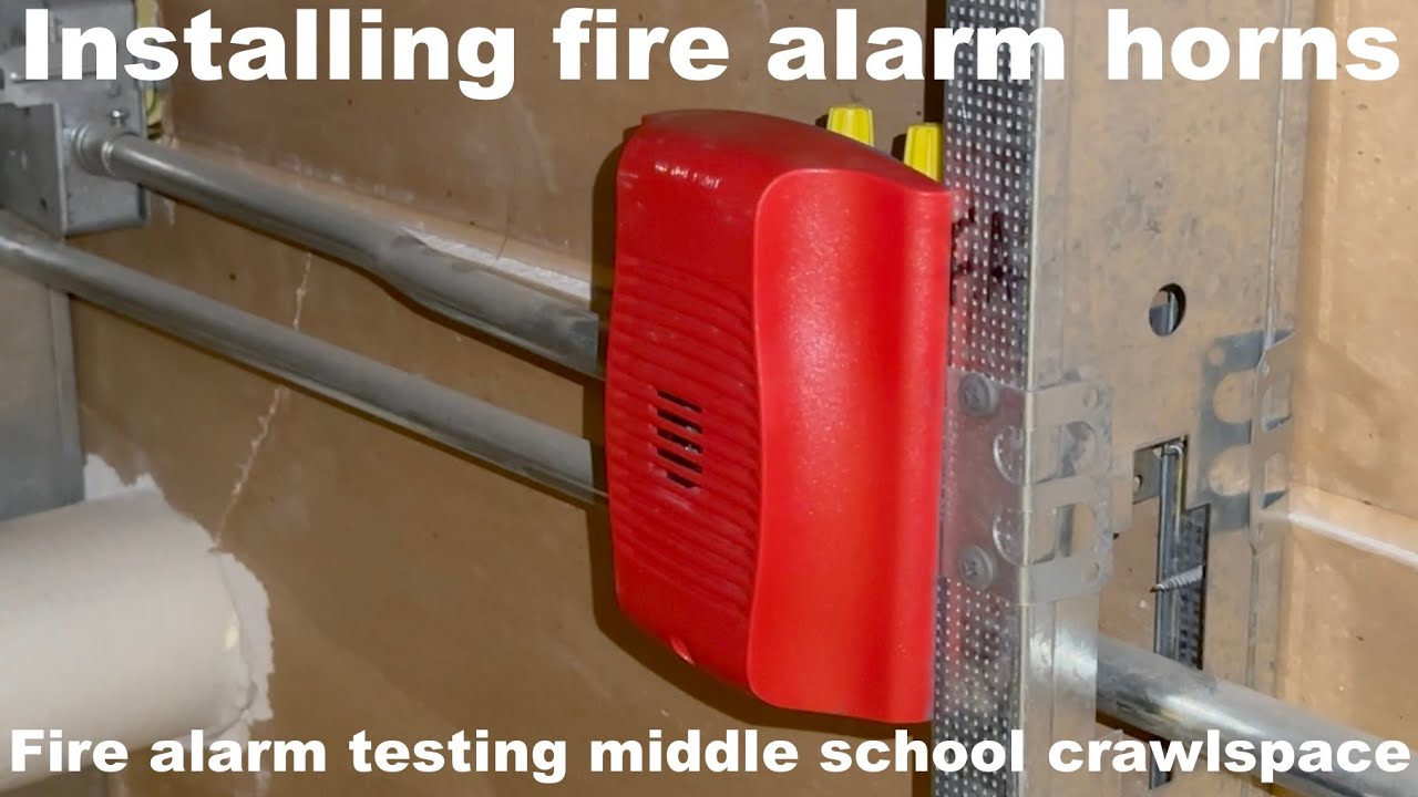 Installing fire alarm horns and fire alarm testing crawlspace at middle school