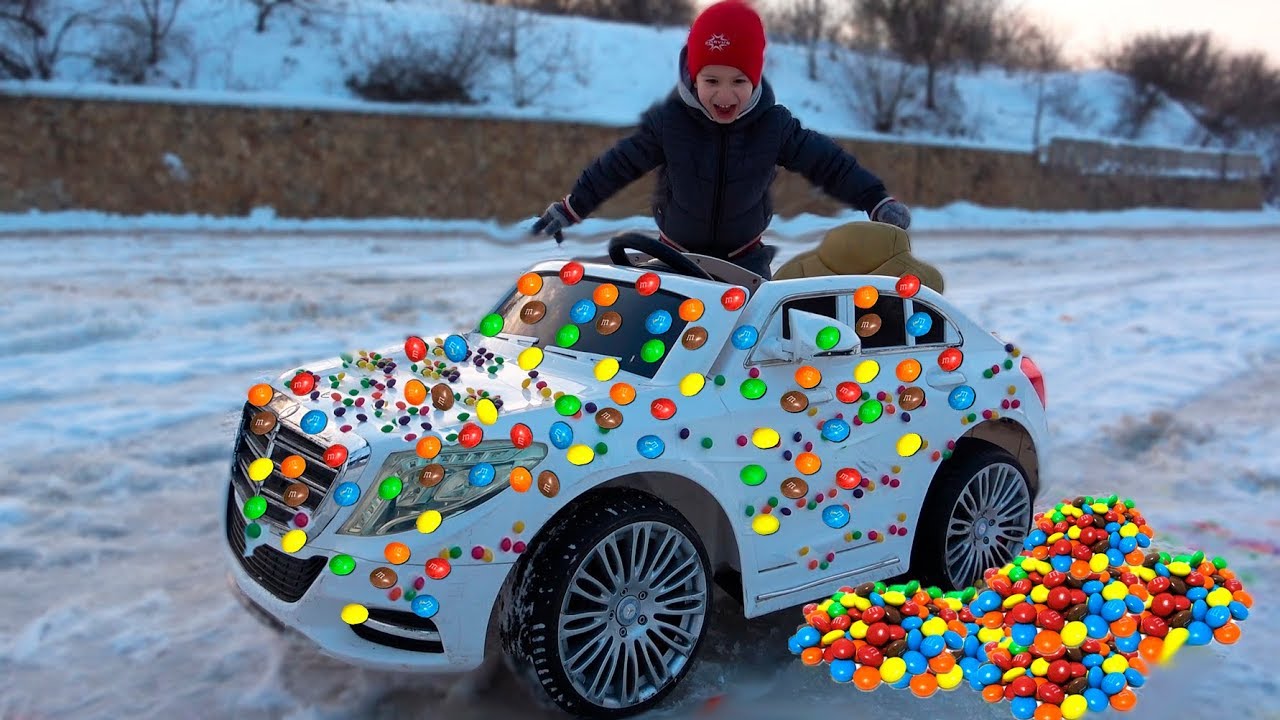 Kid Rides on Power Wheels 12 volt Baby Car and the Wheel stuck in lots of Candy / Children's video