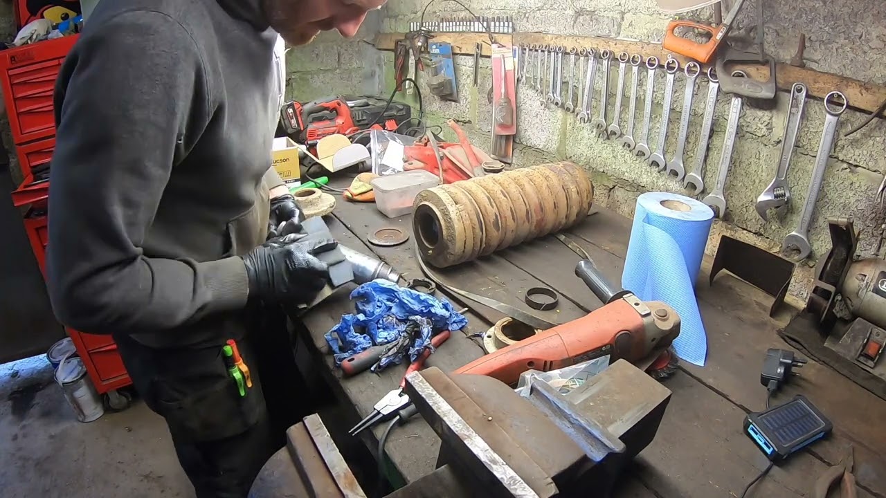 Track tensioner rebuild and excavator undercarriage fork re-adjustment