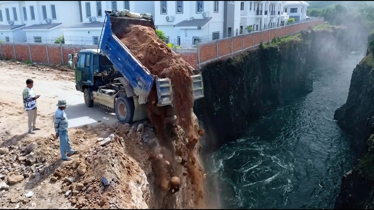 Bulldozer R2 Rank Pushing soil remove flooded by Truck Kumatsu