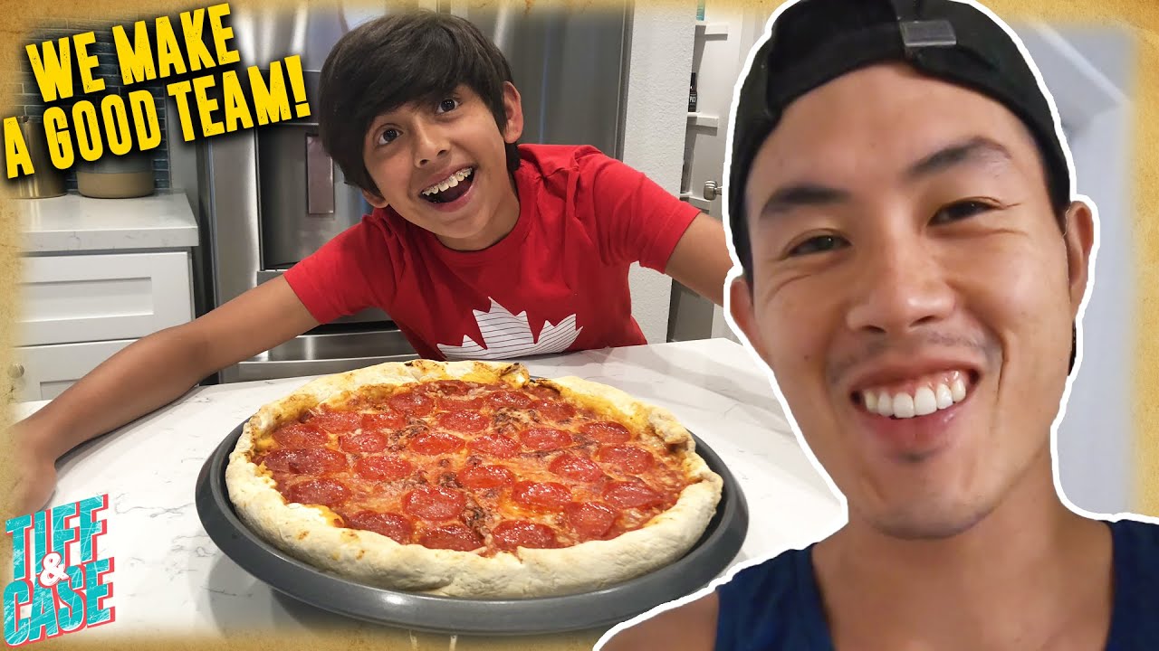 Father and son make pizza for the first time