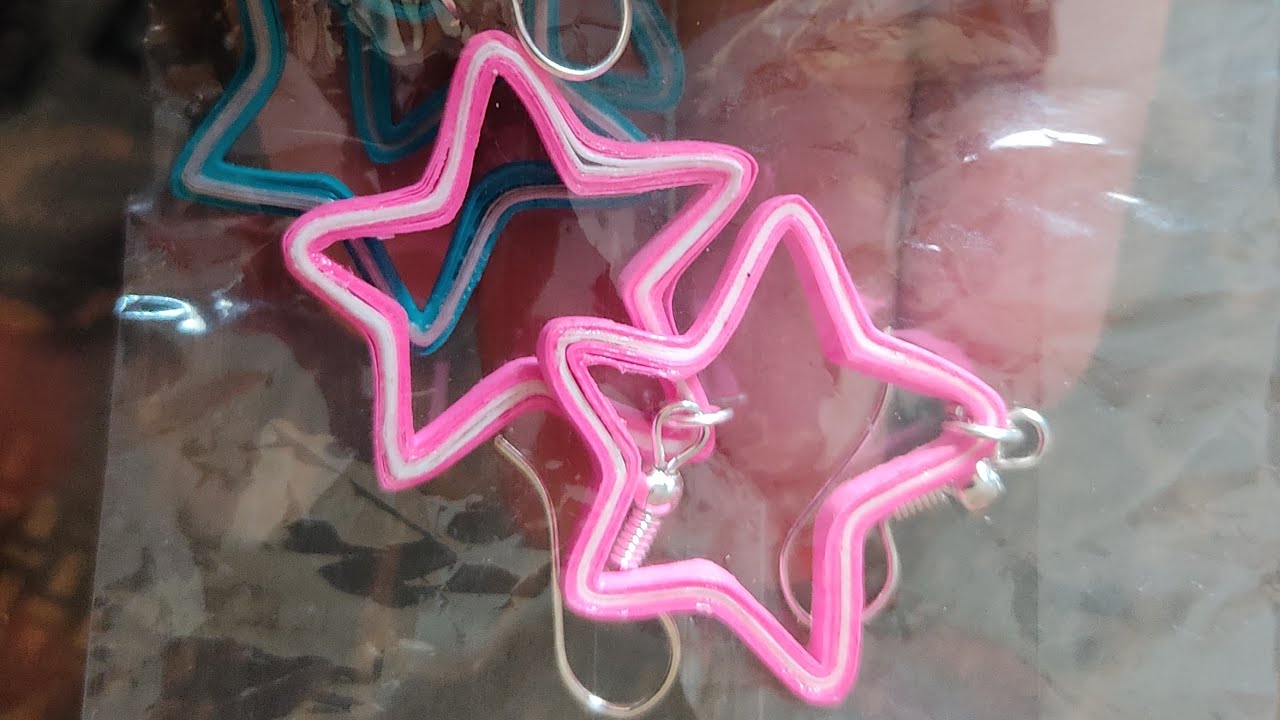 Making of star shaped quilled earrings