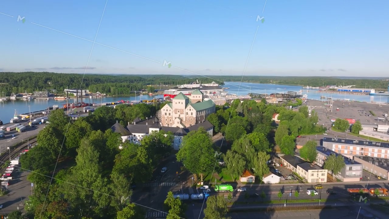 Turku, Finland features the picturesque waterfront castle embraced by lush greenery and a bustling