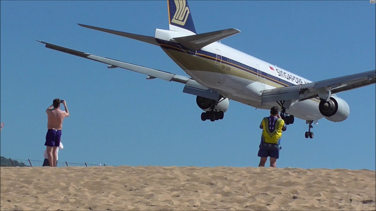 Planes over beach landing at Phuket Airport.