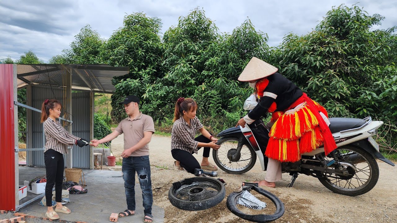 Girl Building a house with cement columns . Changing motorbike inner tubes for a Dao ethnic girl