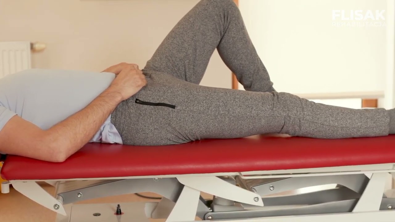 16.Rolling miednicy w pozycji horyzontalnej z 1 nogą wyprostowaną Rehabilitacja Fizjoterapia Skawina