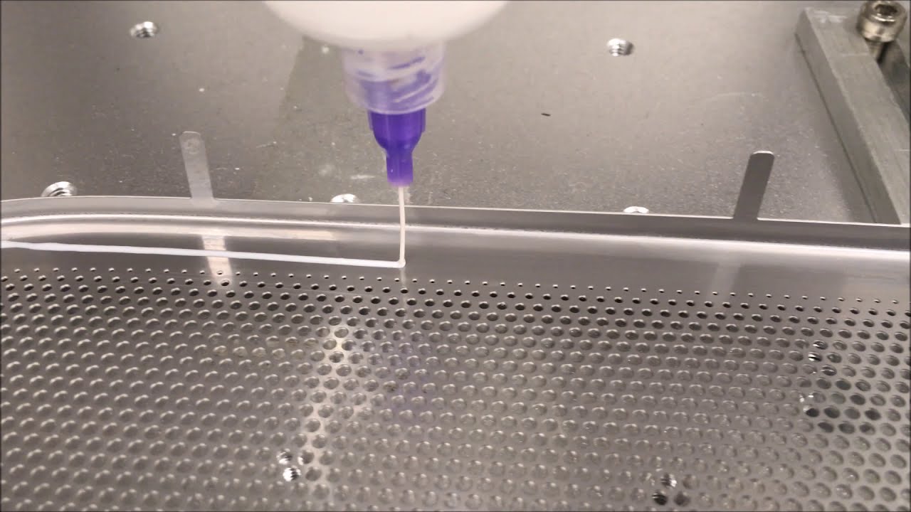 Adhesive Dispensing Ltd - Robot Dispenser Making Beads of PVA glue to speaker grille
