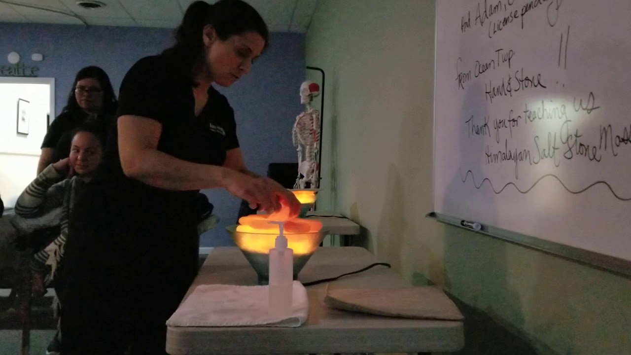 Hand & Stone visits our Night Class to demo Himalayan Salt Stone Massage