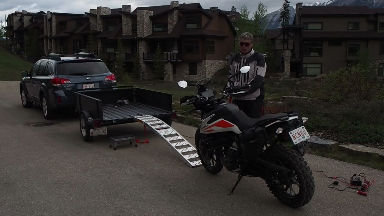 How to load a motorcycle single-handedly onto a trailer using an electric winch in relative safety
