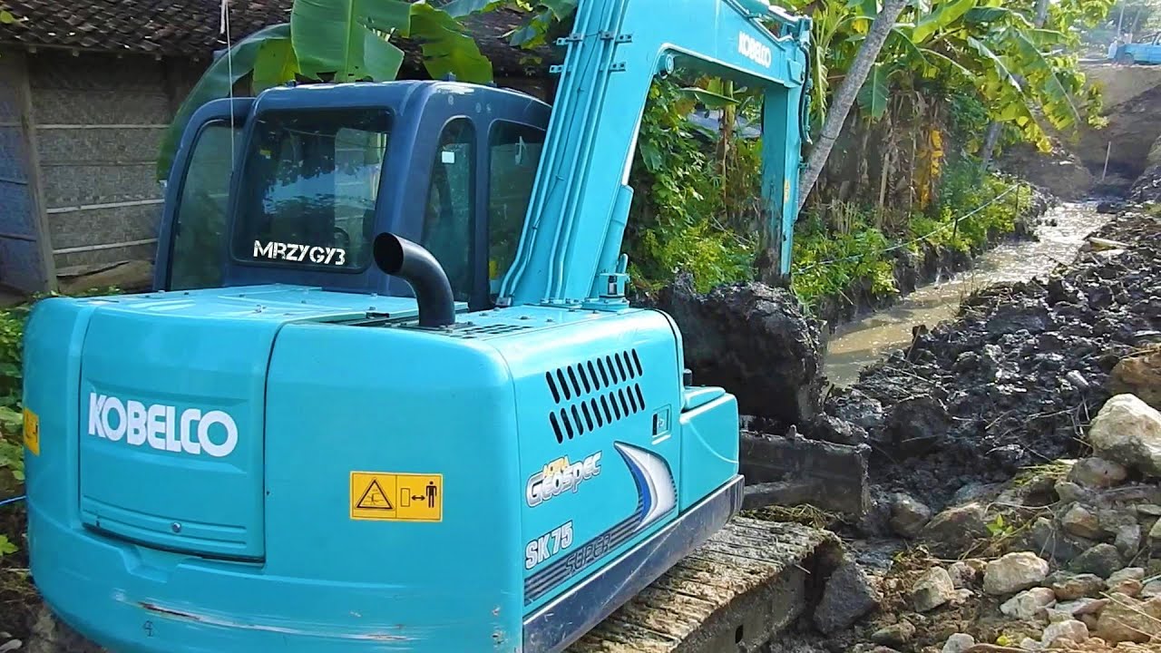 Mini Excavator Digging Trench Kobelco SK75