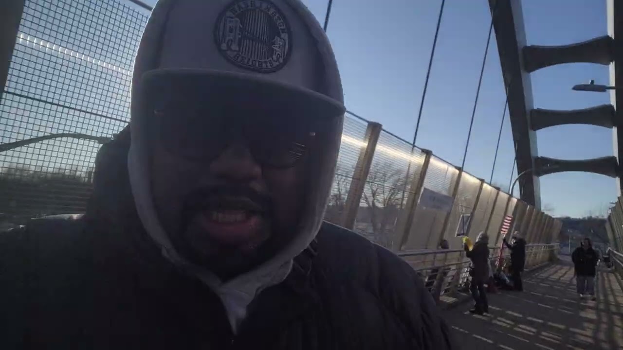 Walking over the Herman Denny Farrell bridge over the west side highway in NYC.