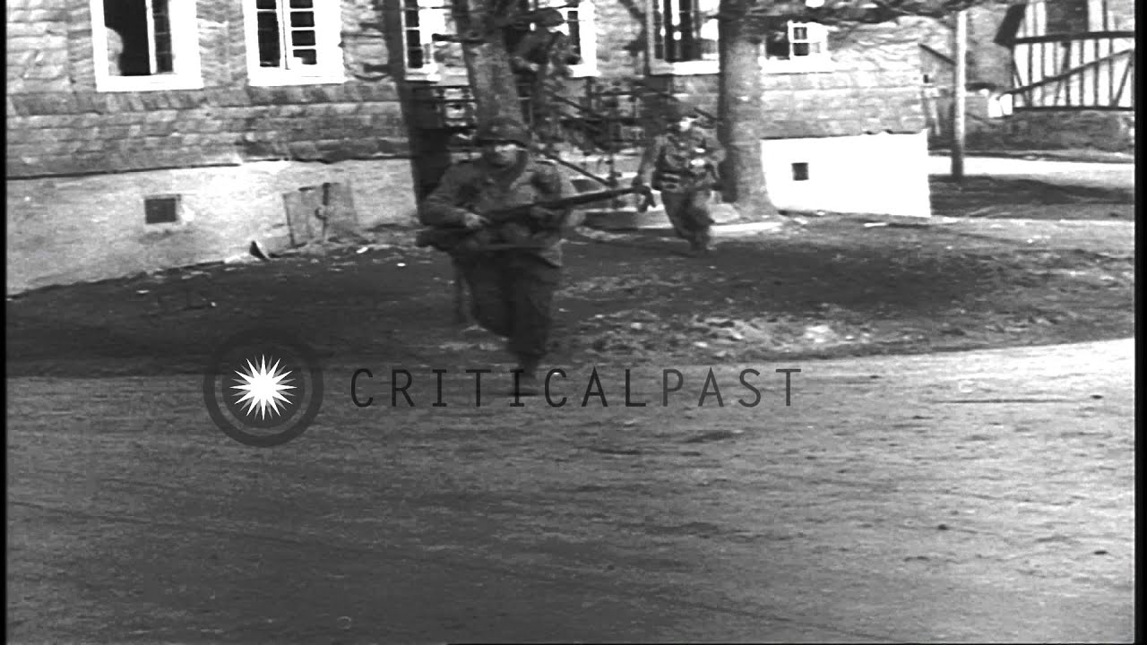 Soldiers fire 30 caliber machine guns and run across a street in Wurdinghausen, G...HD Stock Footage
