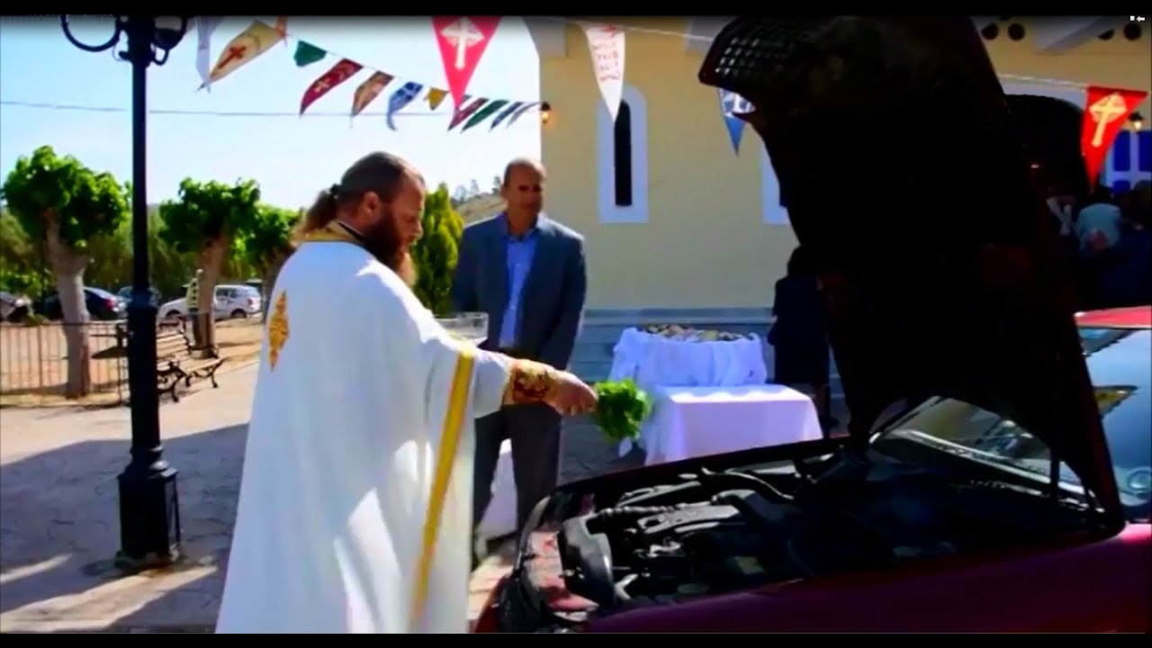 Priest blessing cars in Greek village