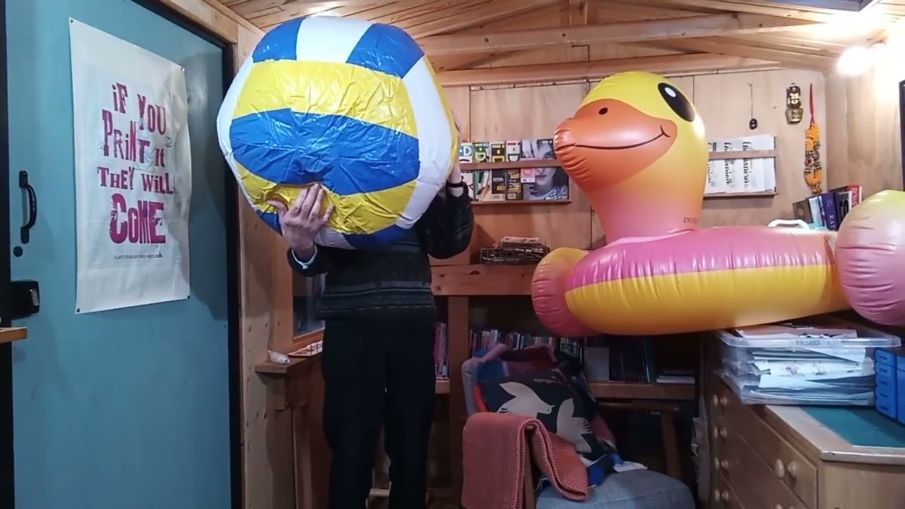 Ballooner Tick blows up a gigantic beach ball 