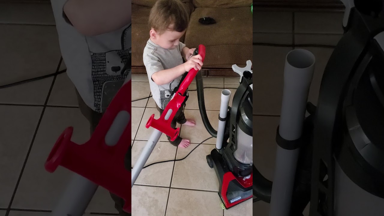 2 year old kid shows off his dirt devil powermax xl vacuum. Playing with vacuum.