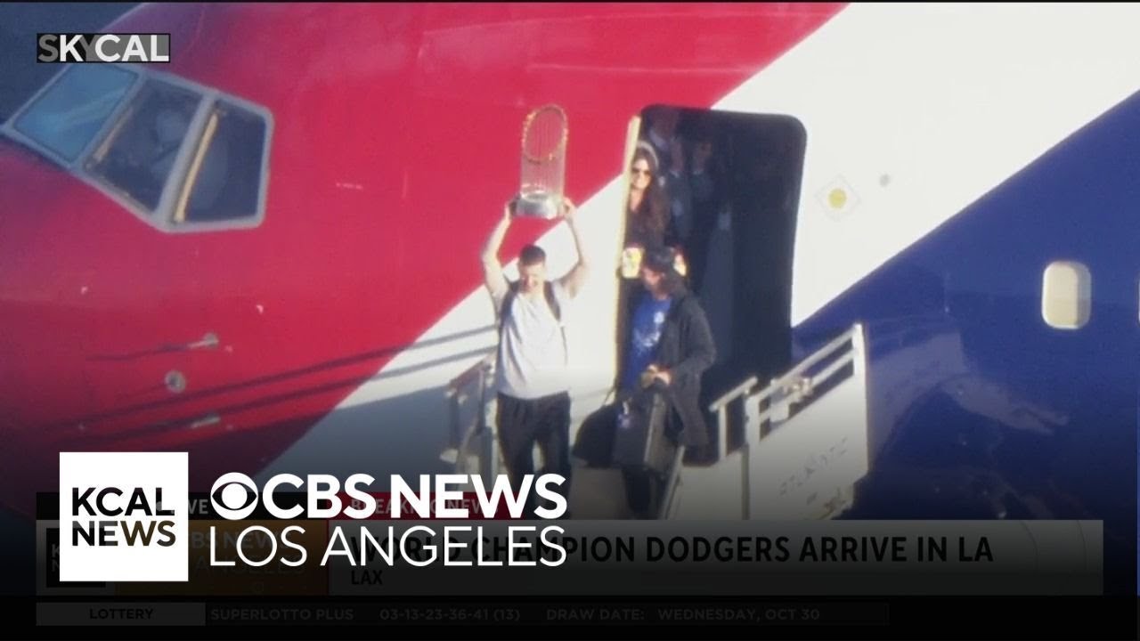 Walker Buehler holds up Commissioner's Trophy as Dodgers land at LAX