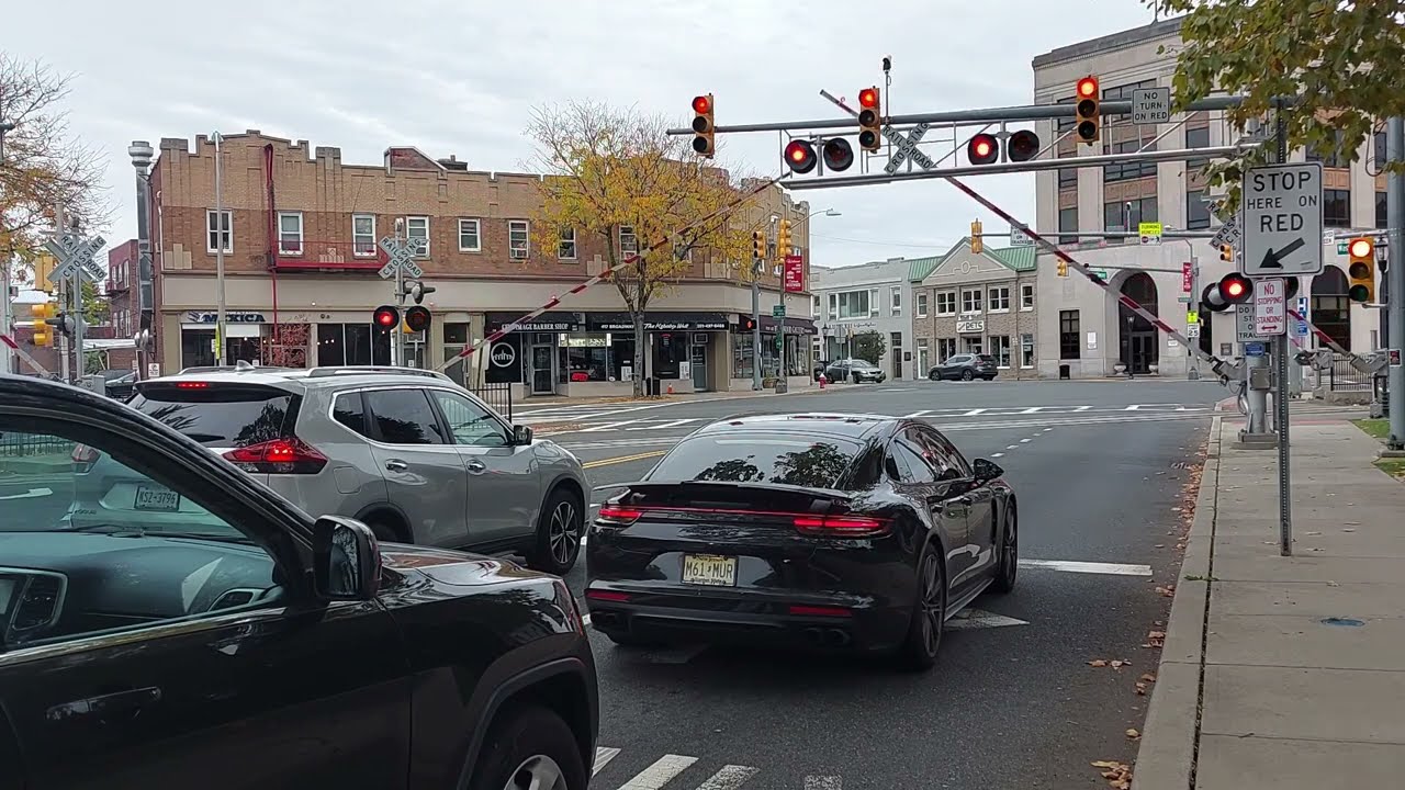 NJ Transit trains roars through very busy level crossing