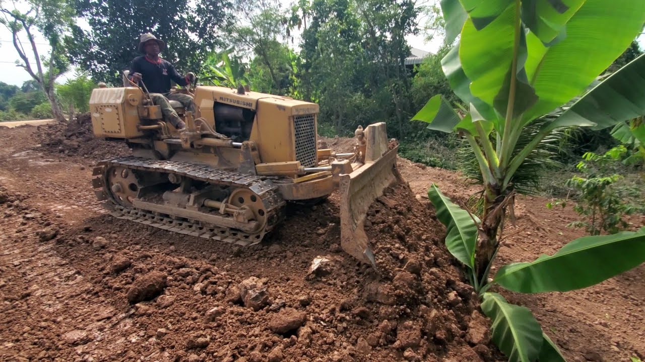 Great job !! Dump truck unloading soil landfilling with bulldozer pushing soil fill flood area 