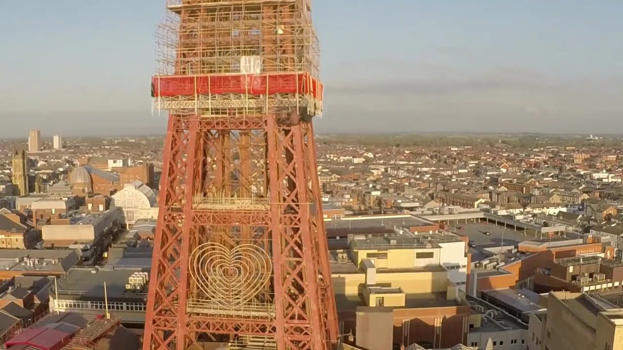 Quadcopter Drone flying to the top of Blackpool Tower.