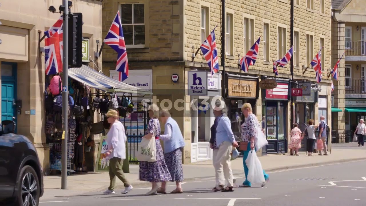 People, Traffic And Union Jack Flags On Matlock Street, Bakewell, UK