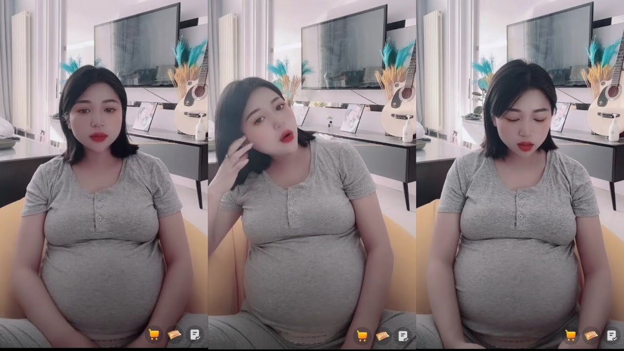 Pregnant asian mom talking 9 month pregnancy
