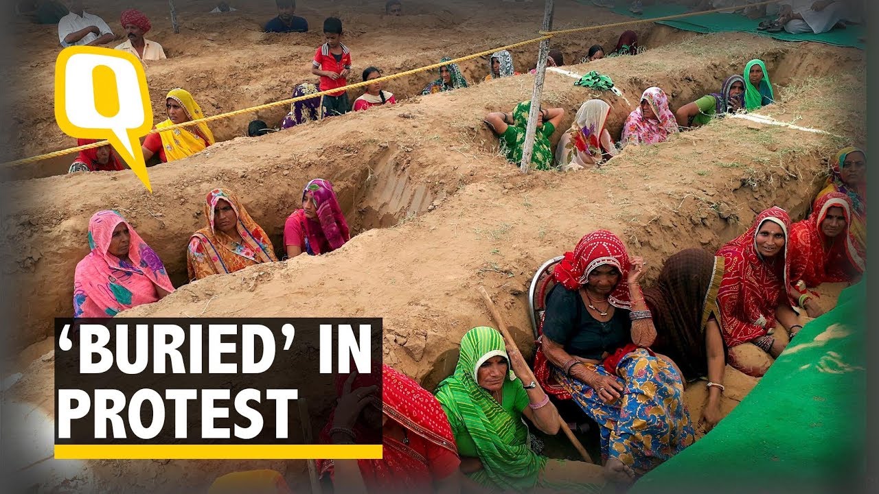 Farmers Bury Themselves Neck-Deep to Protest Land Acquisition - The Quint