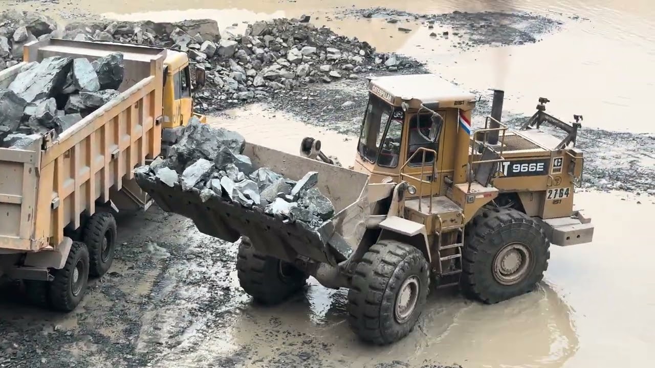 Caterpillar loader loading stones into truck Heavy equipment working 💪🚜