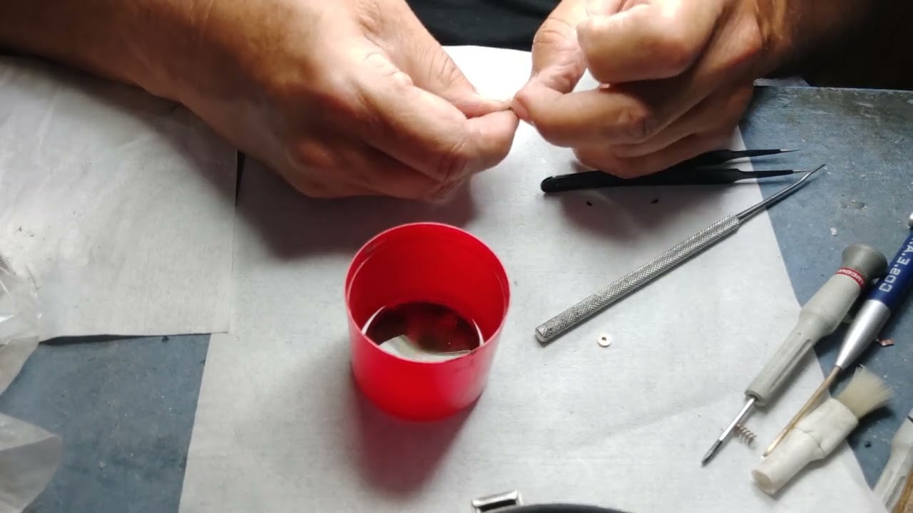 Dupont lighter repairing a crimped gas refill valve and disassemble the valve without original keys