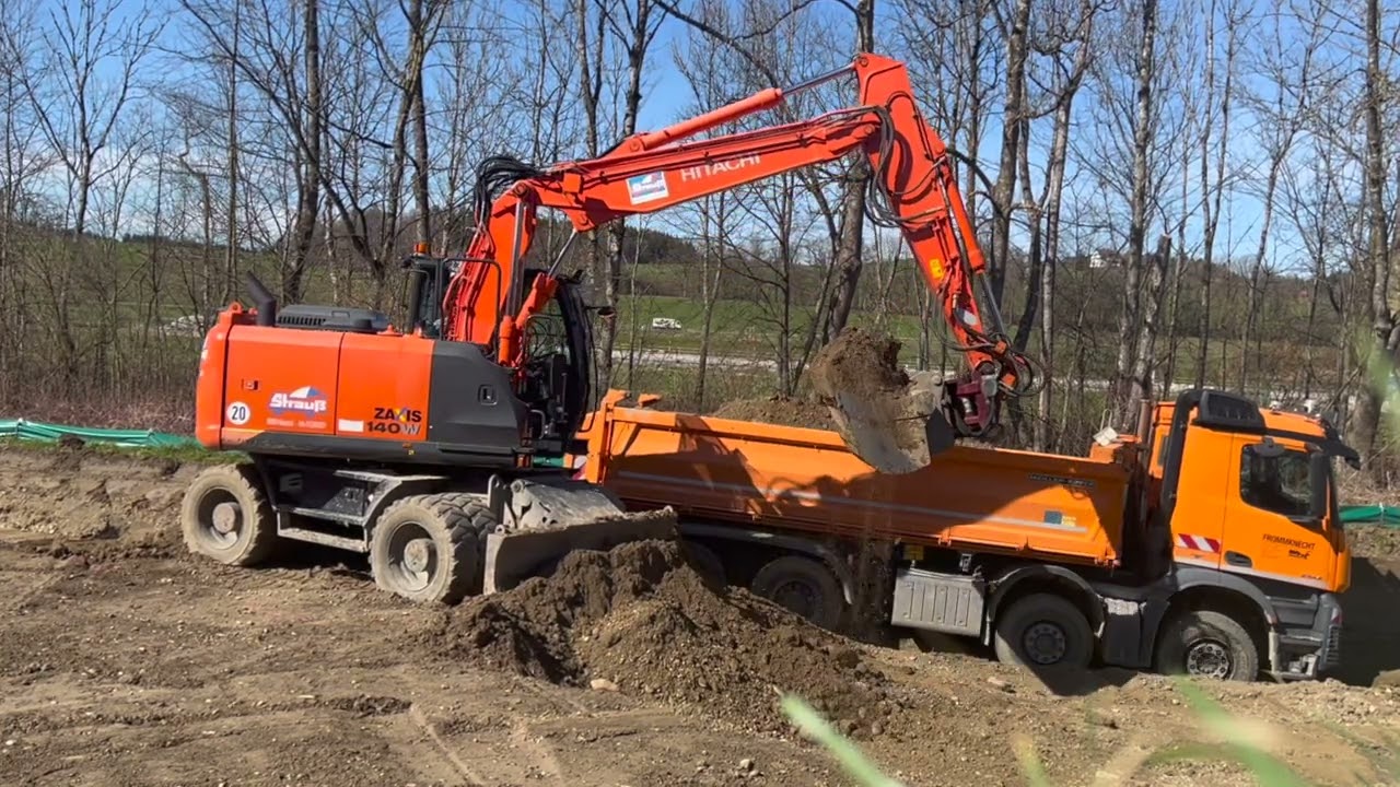 Bau der Landesgartenschau 2024 - Mobilbagger Hitachi ZX140W+ Powertilt/excavator loads truck/Part1